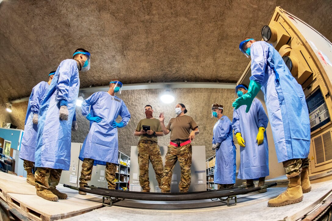 Air Force service members wearing personal protective equipment in Negative Pressurized Conex- Lite training.