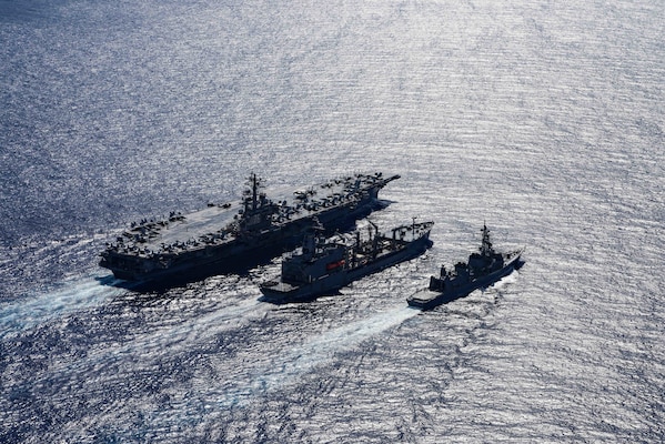 The Navy's only forward-deployed aircraft carrier USS Ronald Reagan (CVN 76), left, fleet replenishment oiler USNS John Ericsson (T-AO 194), middle, and the Japanese Maritime Self-Defense Force Murasame-class destroyer Ikazuchi (JS 107) steam ahead while conducting a replenishment-at-sea.