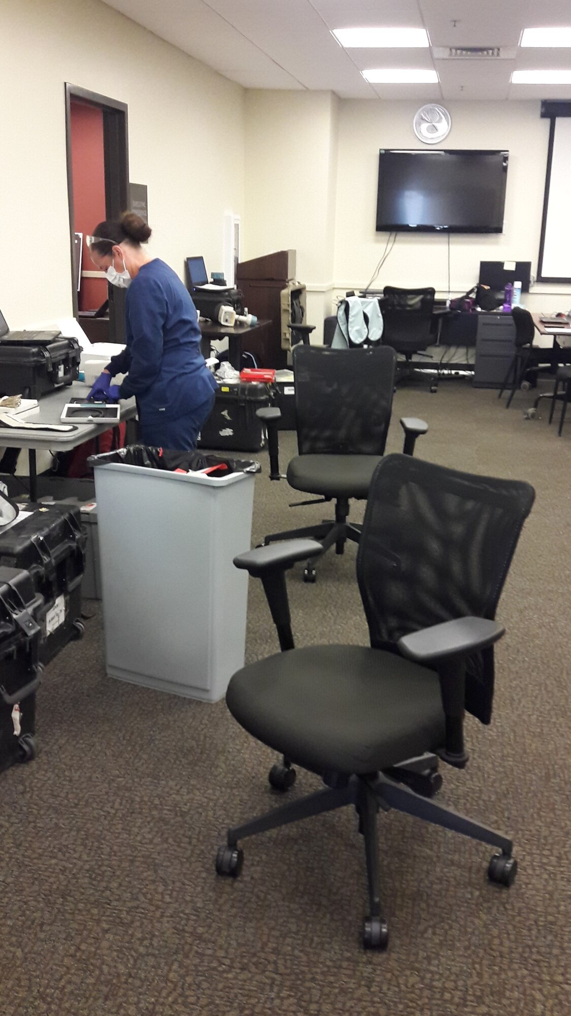 Technician is preparing the clinic space to receive patients and implementing safe practice used under COVID-19 guidelines.