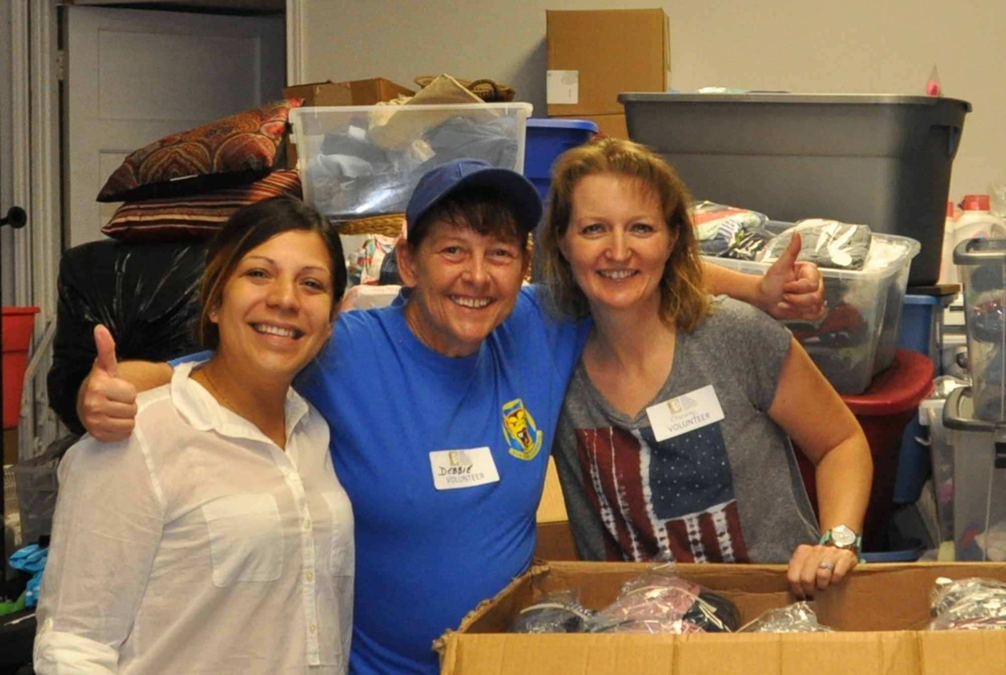 Chastity Ramirez  (right) and Debbie Gildea (center) pose for a photo with Priscilla Mendoza, San Antonio, Texas Family Violence Prevention Services/Battered Women and Children’s Shelter’s Donation Center assistant (left), during the 340th Flying Training Group's  Sept. 11, 2020 community outreach event. Mendoza said the 16 boxes sorted and packed by 340th FTG members saved the center a week of work. (U.S. Air Force photo by Janis El Shabazz)