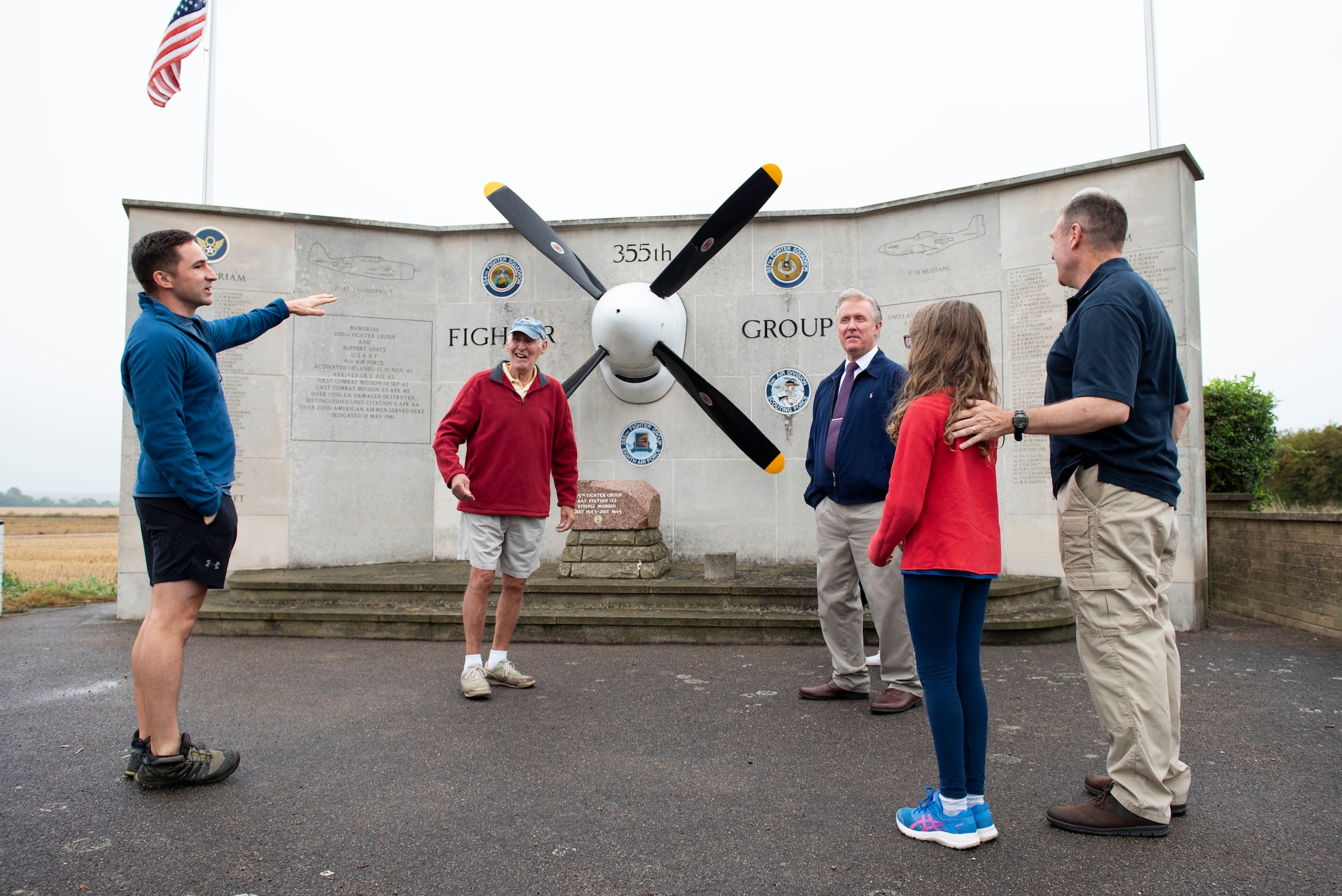U.S. Army Capt. Chris Philhower (left), U.S. Africa Command Directorate for Intelligence at RAF Molesworth technician, speaks with David Crow (second from left), a local from Steeple Morden who helped build the memorial, during Operation TORCH-2020 memorial cleanup August 15, 2020. U.S. Africa Command Directorate for Intelligence at RAF Molesworth partnered with the American Battle Monuments Commission to host Operation TORCH-2020, where over 50 military members and their families, U.K. nationals and Boy Scout Troop #245, cleaned six WWII memorial sites to preserve American service member legacies and promote an appreciation of past American heroes among present-day USAFRICOM workforce and families. (U.S. Air Force Photo by Airman 1st Class Jennifer Zima)