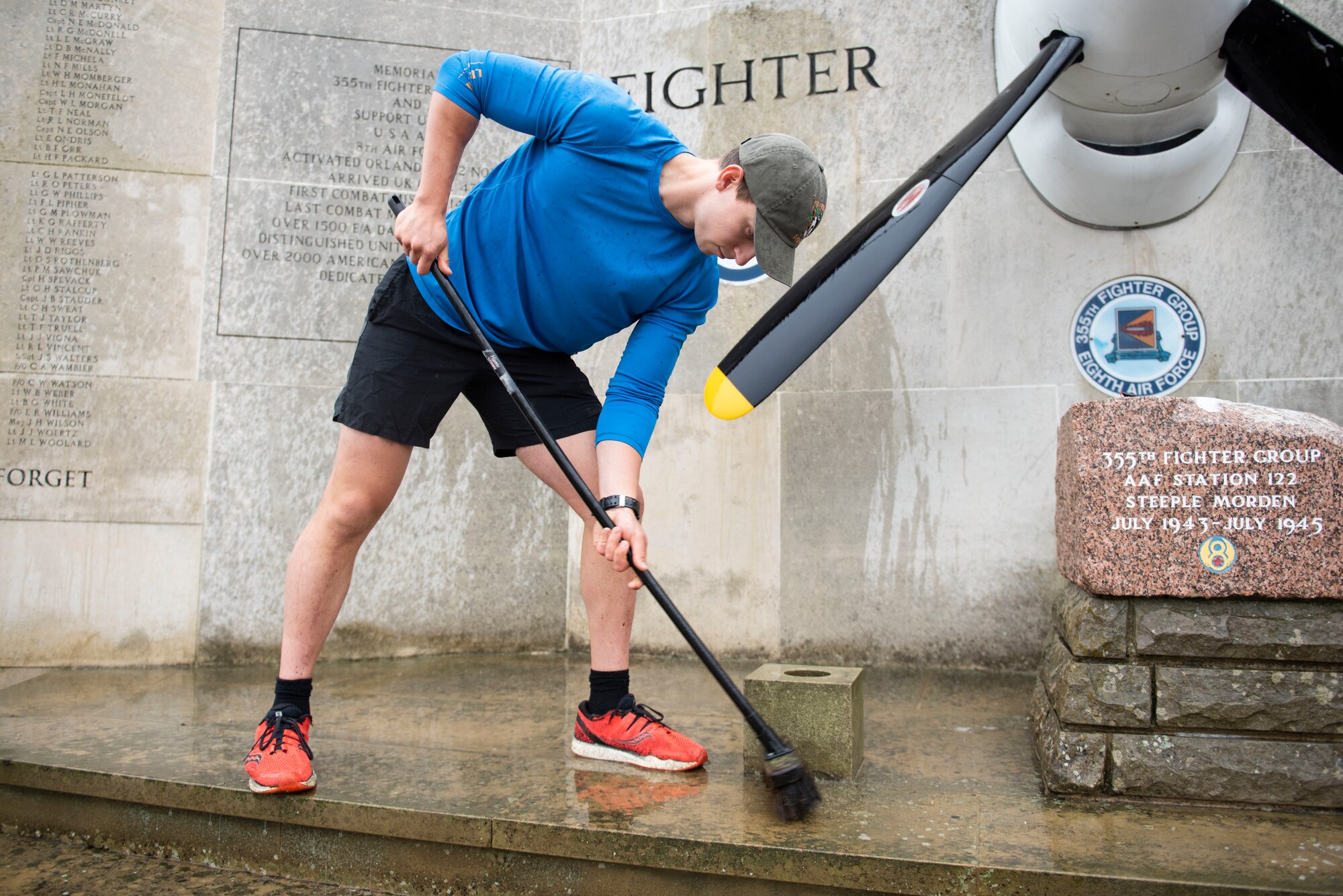 U.S. Navy Petty Officer 2nd Class Sebastian Botero, U.S. Africa Command Directorate for Intelligence at RAF Molesworth technician, scrubs the 355th Fighter Group Steeple Morden Memorial in Steeple Morden, England, during Operation TORCH-2020 memorial cleanup August 15, 2020. U.S. Africa Command Directorate for Intelligence at RAF Molesworth partnered with the American Battle Monuments Commission to host Operation TORCH-2020, where over 50 military members and their families, U.K. nationals and Boy Scout Troop #245, cleaned six WWII memorial sites to preserve American service member legacies and promote an appreciation of past American heroes among present-day USAFRICOM workforce and families. (U.S. Air Force Photo by Airman 1st Class Jennifer Zima)