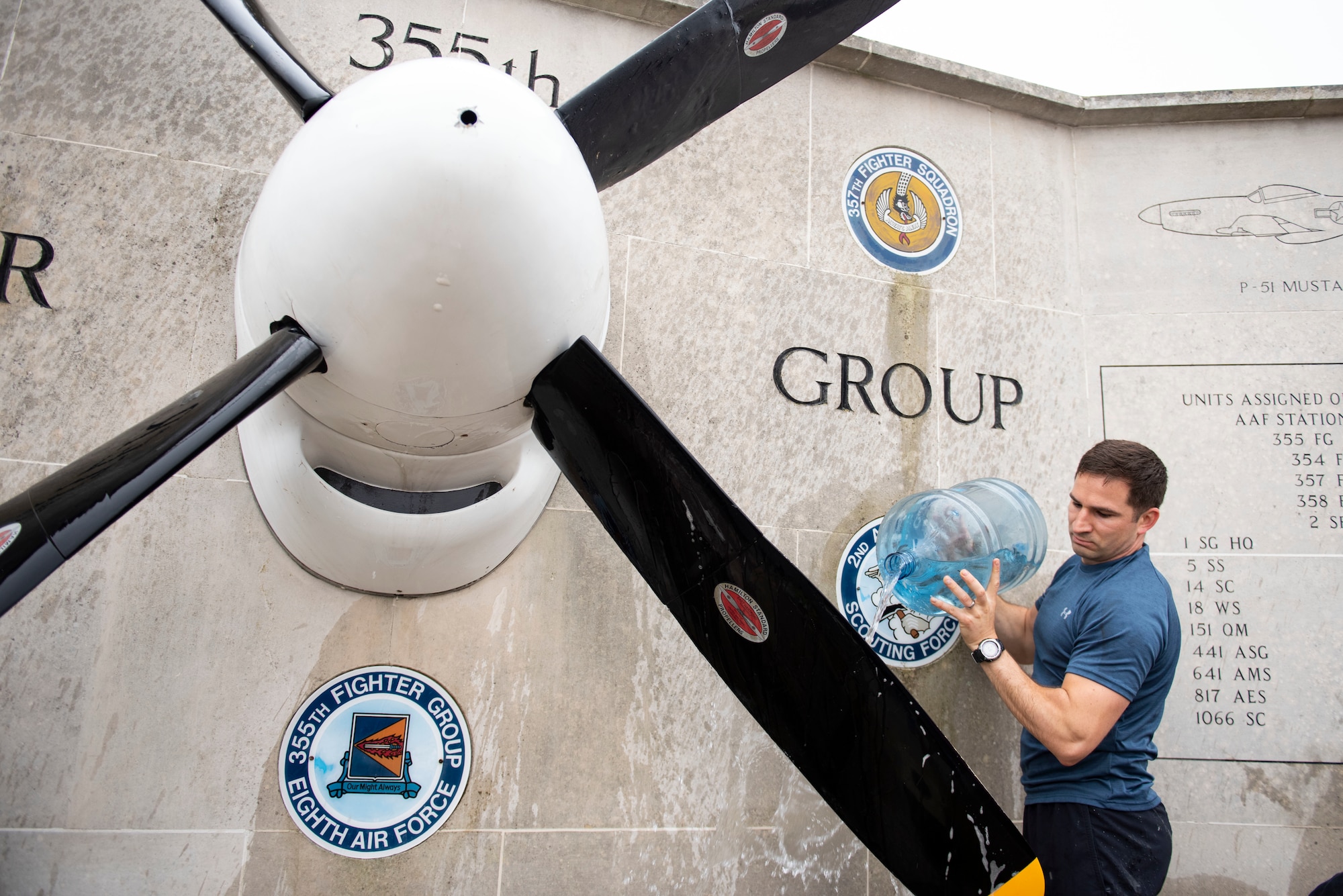 U.S. Army Capt. Chris Philhower, U.S. Africa Command Directorate for Intelligence at RAF Molesworth technician, cleans the 355th Fighter Group Steeple Morden Memorial in Steeple Morden, England, during Operation TORCH-2020 memorial cleanup August 15, 2020. U.S. Africa Command Directorate for Intelligence at RAF Molesworth partnered with the American Battle Monuments Commission to host Operation TORCH-2020, where over 50 military members and their families, U.K. nationals and Boy Scout Troop #245, cleaned six WWII memorial sites to preserve American service member legacies and promote an appreciation of past American heroes among present-day USAFRICOM workforce and families. (U.S. Air Force Photo by Airman 1st Class Jennifer Zima)