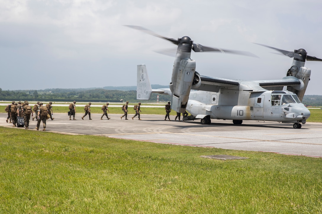U.S. Marines with 3d Marine Expeditionary Brigade board an MV-22B Osprey with Marine Medium Tiltrotor Squadron 265, 1st Marine Aircraft Wing, during a flyaway drill on the flight line of Kadena Air Base, Okinawa, Japan, Aug. 18, 2020. The MEB continues to conduct essential, realistic training while adhering to strict COVID-19 safety protocols to mitigate the spread of COVID-19 and are prepared to deploy in support of our allies and partners throughout the region. 3d MEB is structured to rapidly respond to crisis around the globe immediately, effectively, and efficiently, whether they are humanitarian or combat-related.  (U.S. Marine Corps photo by Lance Cpl. Hannah Hall)