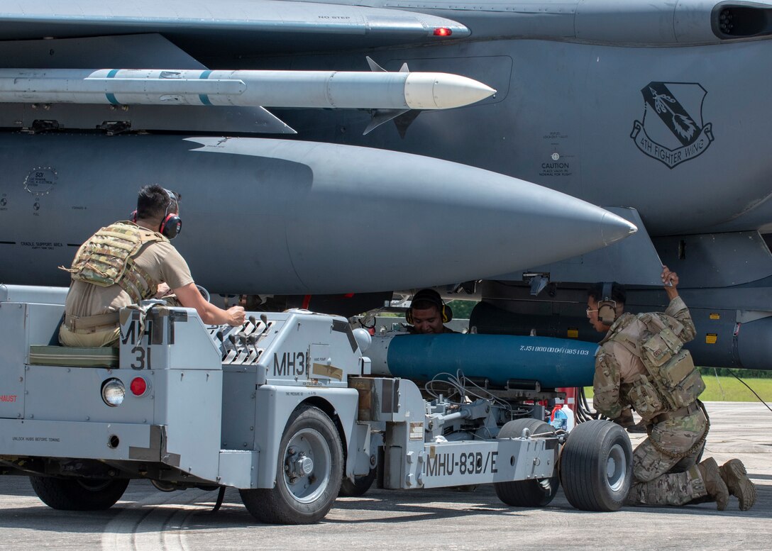 Airmen from Seymour Johnson Air Force Base load munitions onto an F-15E Strike Eagle during Razor Talon at Cherry Point Marine Corp Air Station, North Carolina, Aug.12, 2020.