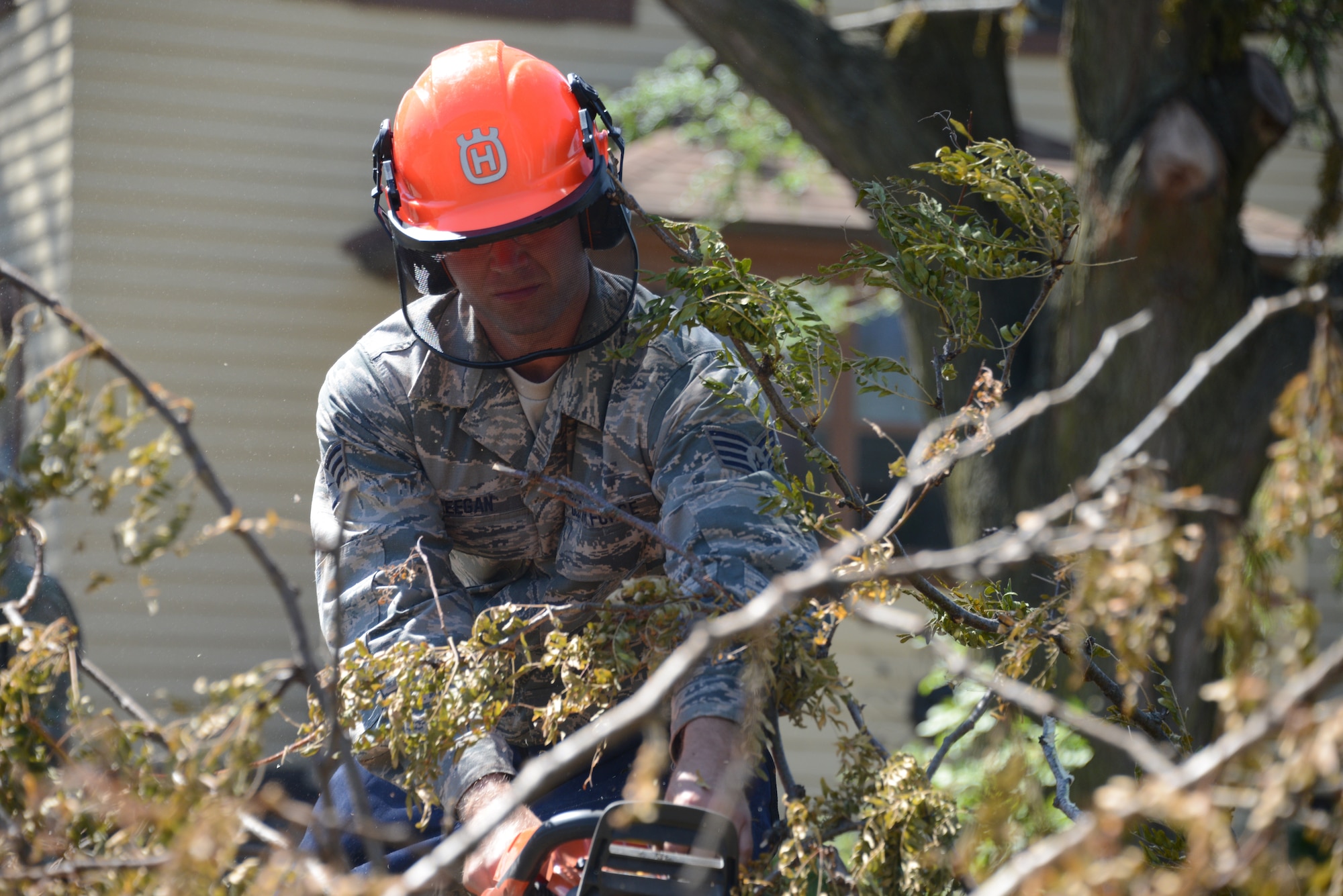 Staff Sgt. Jerad Keegan, 185th Air Refueling Wing Civil Engineering Squadron, Iowa Air National Guard, uses a chain saw to clear downed trees in Cedar Rapids, Iowa, Aug. 18, 2020. Extremely high winds uprooted trees and caused widespread structural damage and power outages throughout Southeast Iowa.