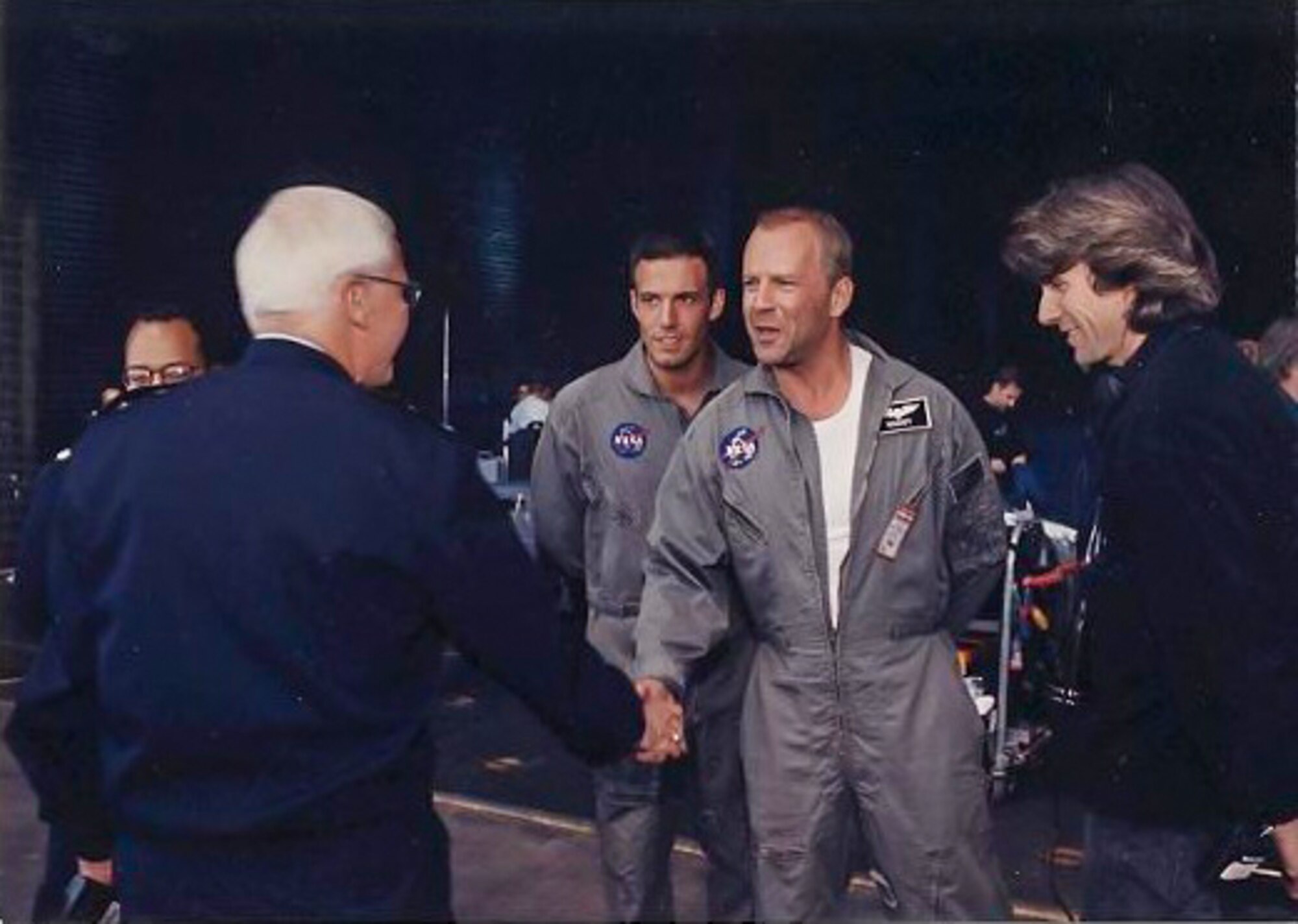 Actors Ben Affleck and Bruce Willis and director Michael Bay meet Maj. Gen. (retired) Richard Engel, then commander of the Air Force Test Center, during filming of the movie "Armageddon" at Edwards Air Force Base, California. (Photo courtesy of Air Force Test Center History Office)
