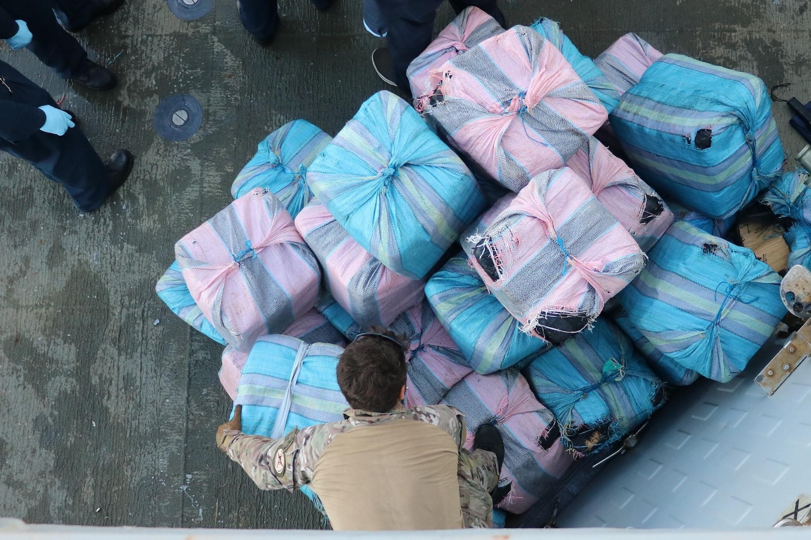 USS Nitze (DDG 94) and embarked U.S. Coast Guard Law Enforcement Detachment transfer suspected contraband on the flight deck of Nitze.