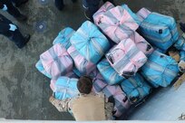 USS Nitze (DDG 94) and embarked U.S. Coast Guard Law Enforcement Detachment transfer suspected contraband on the flight deck of Nitze.
