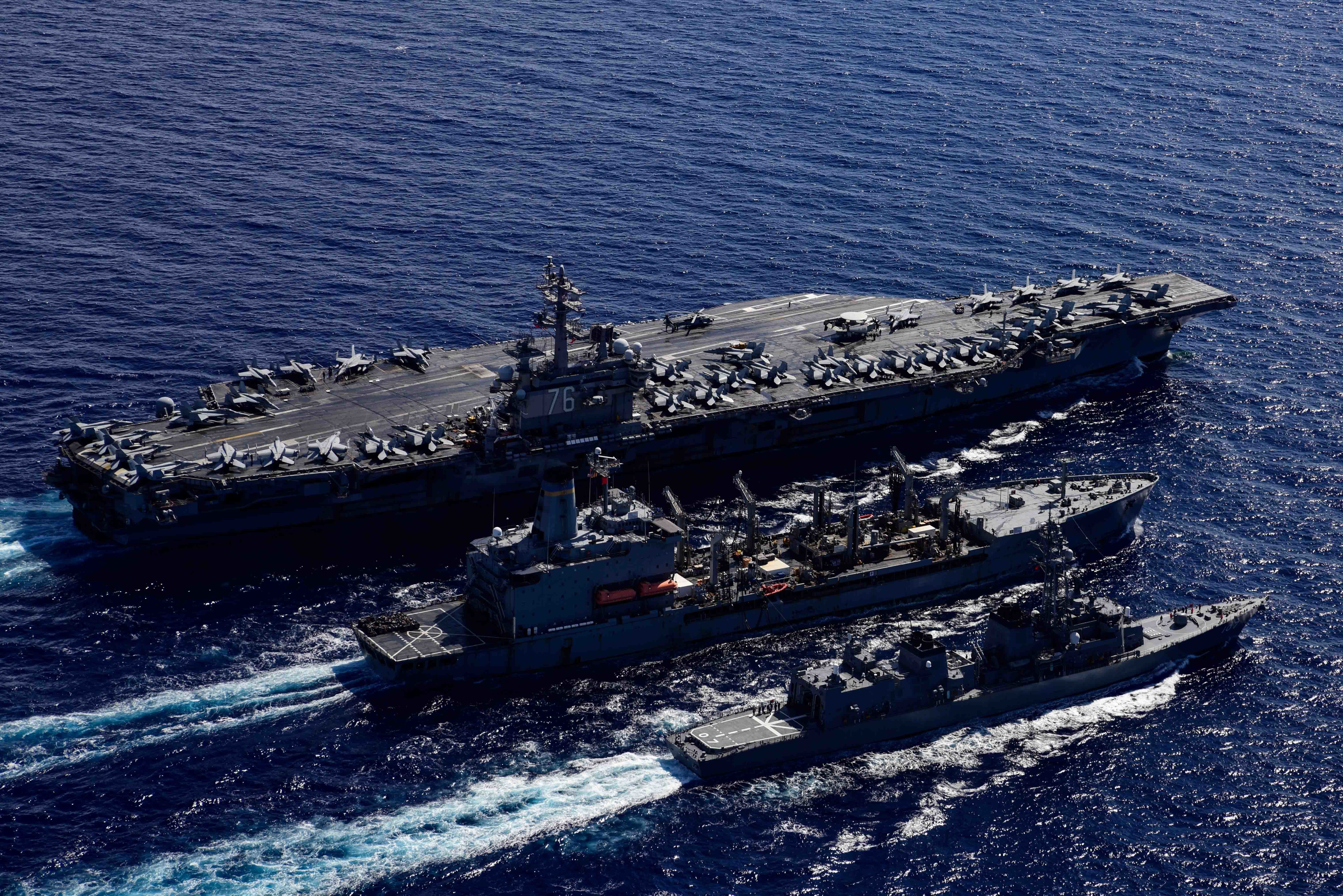 The Navy's only forward-deployed aircraft carrier USS Ronald Reagan (CVN 76), left, fleet replenishment oiler USNS John Ericsson (T-AO 194), middle, and the Japanese Maritime Self-Defense Force Murasame-class destroyer Ikazuchi (JS 107) steam ahead while conducting a replenishment-at-sea.