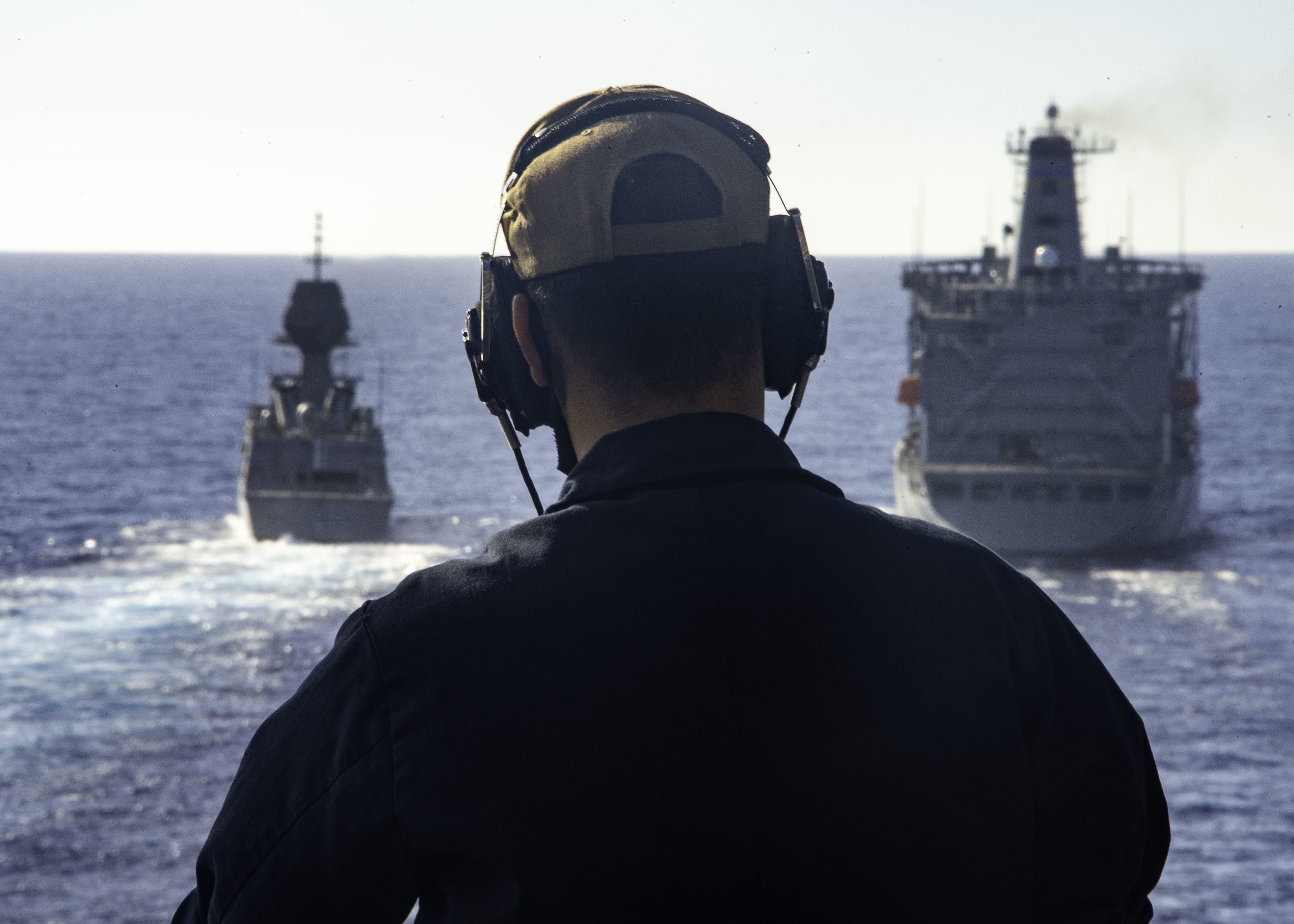 U.S. Navy Seaman Keith Vang, from Stockton, Calif., stands forward lookout watch aboard the Wasp-class amphibious assault ship USS Essex (LHD 2) as the Royal Australian Navy ship HMAS Arunta (FFH 151) transits the Pacific Ocean alongside the U.S. Navy fleet replenishment oiler USNS Henry J. Kaiser (T-AO 187) during Exercise Rim of the Pacific (RIMPAC) 2020.