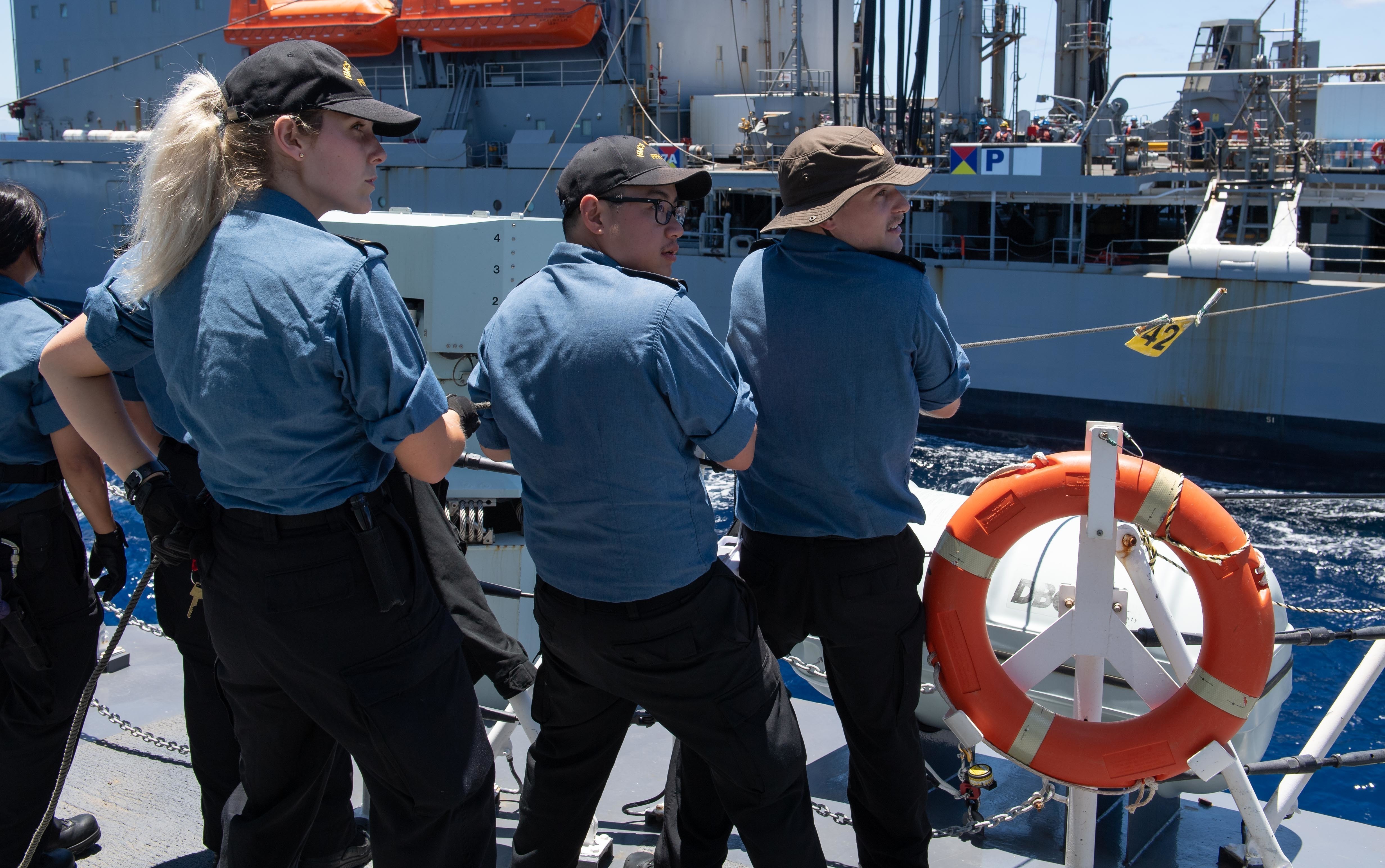 Royal Canadian Navy Ordinary Seaman Kilian Soch participates in a replenishment-at-sea with USNS Henry J. Kaiser (T-AO 187) during Exercise Rim of the Pacific (RIMPAC) 2020.