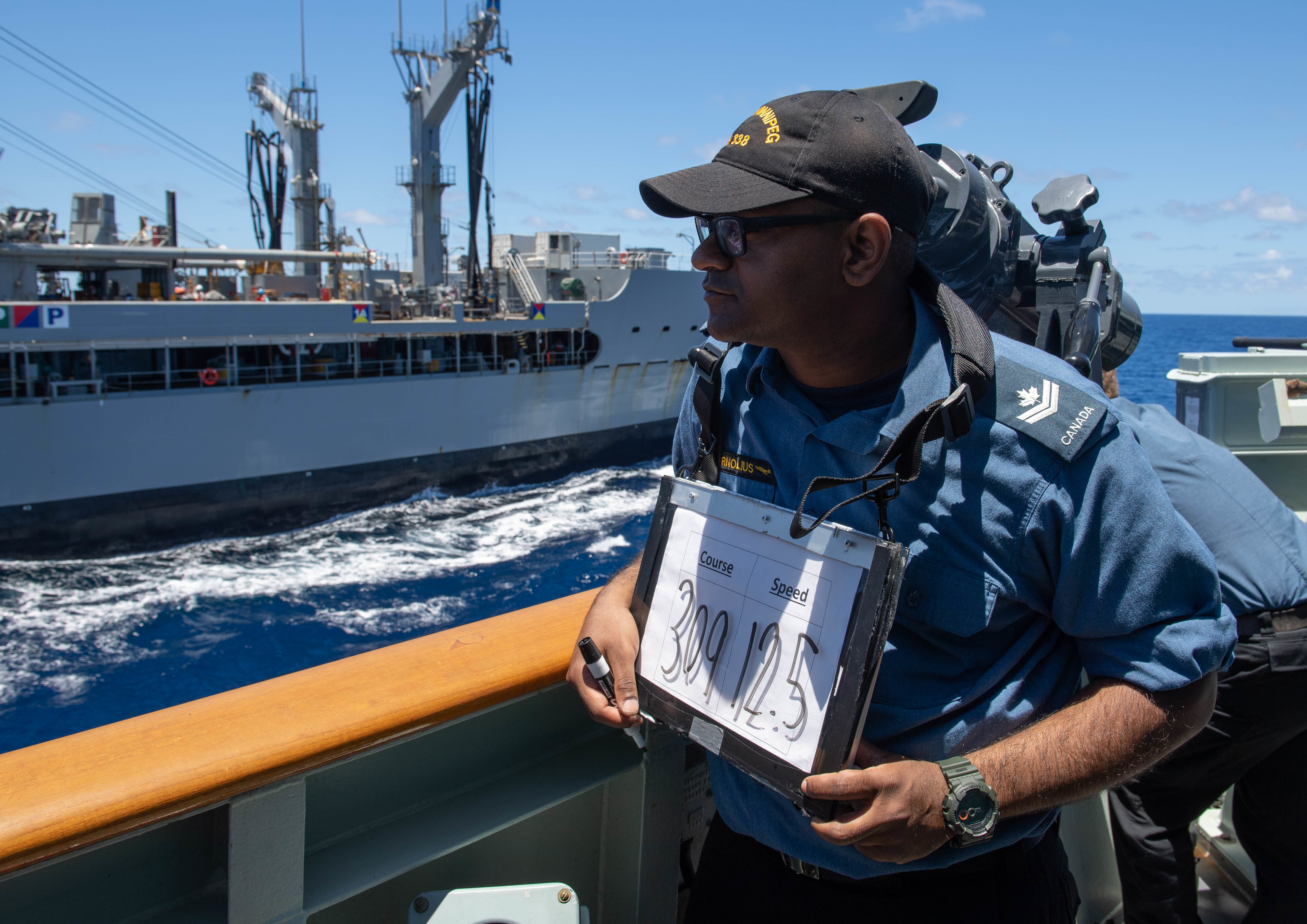 Canadian service member Master Corporal Joseph Cornolius participates in a replenishment-at-sea with the U.S. Military Sealift Command fleet replenishment oiler USNS Henry J. Kaiser (T-AO 187)