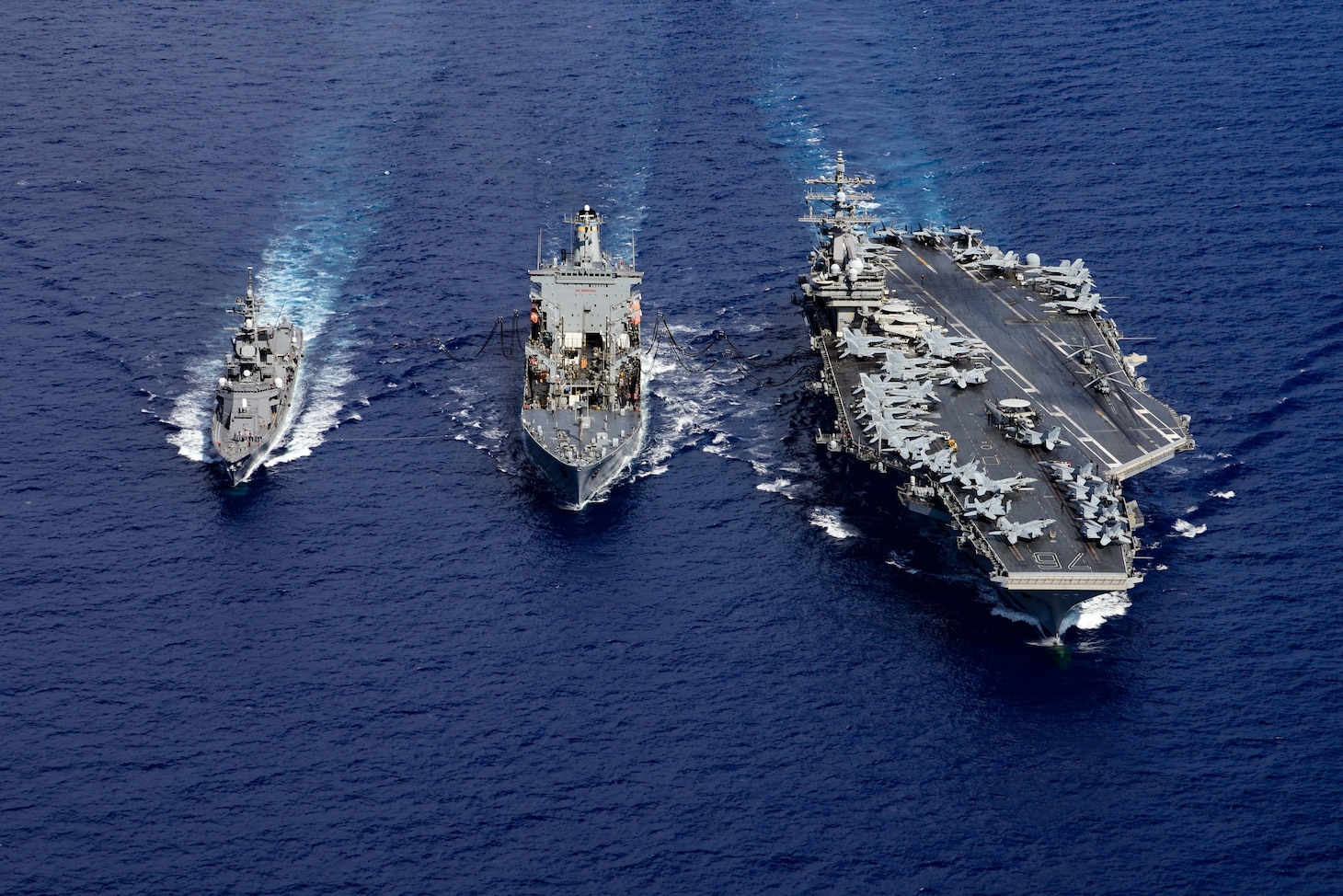 USS Ronald Reagan (CVN 76) is underway with JS Ikazuchi (DD 107) and USNS John Ericsson (T-AO 194).