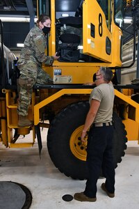 U.S. Air Force Master Sgt. Chad Martin, right, vehicle maintenance specialist for the 115th Fighter Wing Logistics Readiness Squadron, explains unit preventative maintenance measures to 115th LRS first sergeant Master Sgt. Chontelle Southworth, left, at Truax Field in Madison, Wis., July 7, 2020. Southworth was recognized as the 2020 Air National Guard First Sergeant of the Year for her outstanding leadership and dedication.