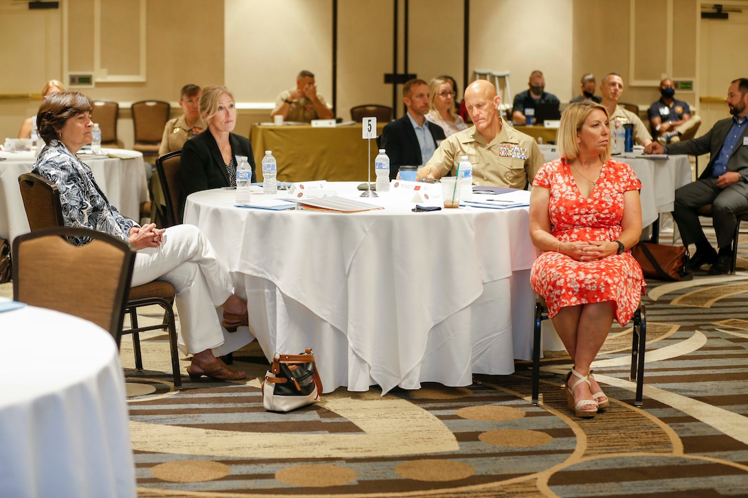 Mrs. Donna Berger and Mrs. Stacie Black sit with Marines and Senior Executive Service members attending the Executive Leadership Orientation and Warfighting Course (ELOWC) held in Alexandria, V.A., Aug. 17, 2020. The purpose of ELOWC was to combine Brigadier General Selection and Orientation Course and the General Officer Warfighting Program. ELOWC is a two-week course held for general officers and Senior Executive Service members. (U.S. Marine Corps photo by Sgt. Victoria Ross)