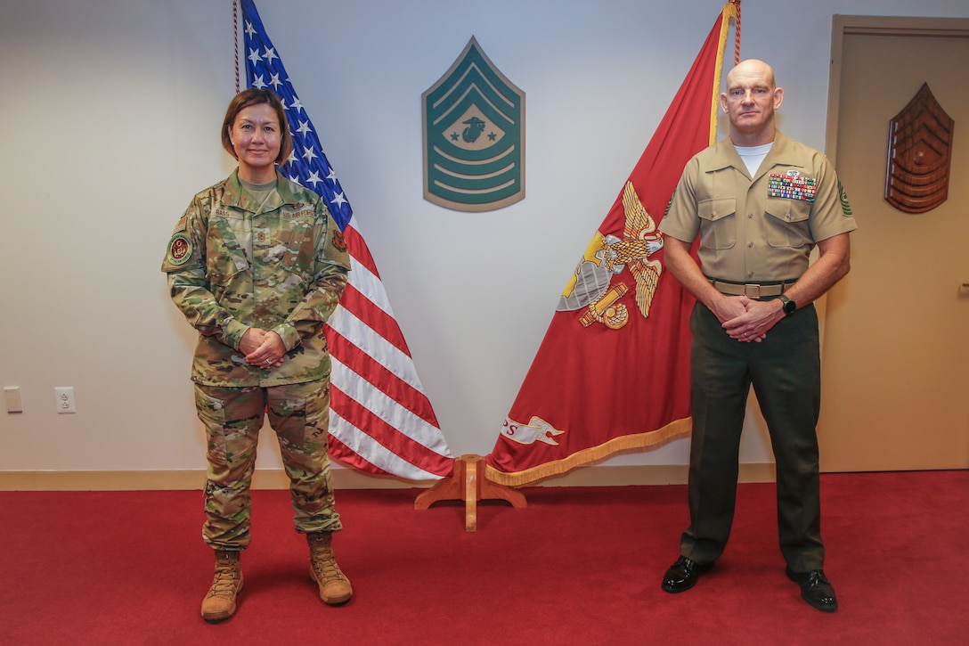 The 19th Sergeant Major of the Marine Corps, Sgt. Maj. Troy E. Black, talks with the newly appointed Chief Master Sergeant of the Air Force, CMSAF JoAnne Bass during an office call in Arlington, V.A., Aug. 18, 2020. The purpose of the office call was to welcome CMSAF Bass as she steps into her role as the most senior enlisted member of the Air Force. Coordination among U.S. military branches facilitates joint endeavors that impact Service Members. (U.S. Marine Corps photo by Sgt. Victoria Ross)