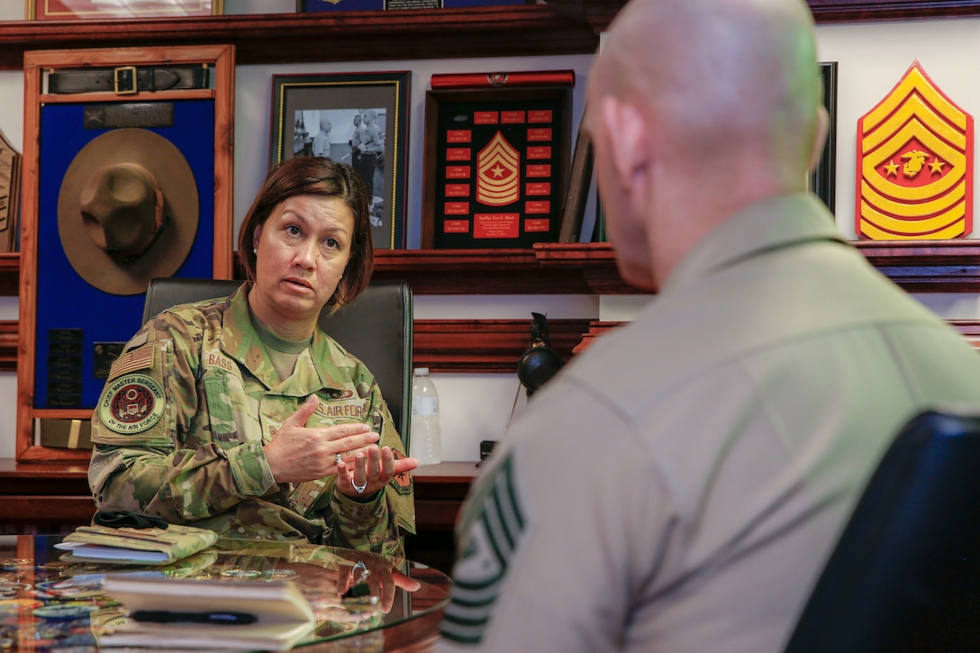 The 19th Sergeant Major of the Marine Corps, Sgt. Maj. Troy E. Black, talks with the newly appointed Chief Master Sergeant of the Air Force, CMSAF JoAnne Bass during an office call in Arlington, V.A., Aug. 18, 2020. The purpose of the office call was to welcome CMSAF Bass as she steps into her role as the most senior enlisted member of the Air Force. Coordination among U.S. military branches facilitates joint endeavors that impact Service Members. (U.S. Marine Corps photo by Sgt. Victoria Ross)