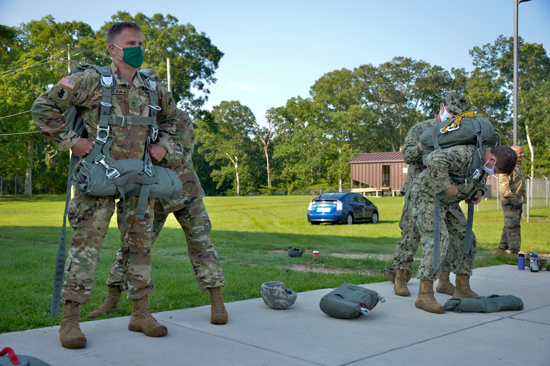 JOINT BASE MCGUIRE-DIX-LAKEHURST, N.J. – Paratroopers with the U.S. Army Reserve’s 404th Civil Affairs Battalion and the U.S. Navy Explosive Ordnance Disposal Mobile Unit 12 don MC-6 parachute systems during an airborne fresher course here on Aug. 12, 2020. The unit conducted joint training in order to maintain mission readiness and proficiency in working with other military service branches.