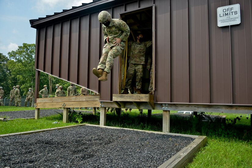 JOINT BASE MCGUIRE-DIX-LAKEHURST, N.J. – A U.S. Army Reserve Paratrooper with the 404th Civil Affairs Battalion practices a landing technique by jumping out of a mock airplane here on Aug. 12, 2020. The unit conducted airborne refresher classes, rehearsals, and training in order to maintain currency among Jumpmasters within the unit.