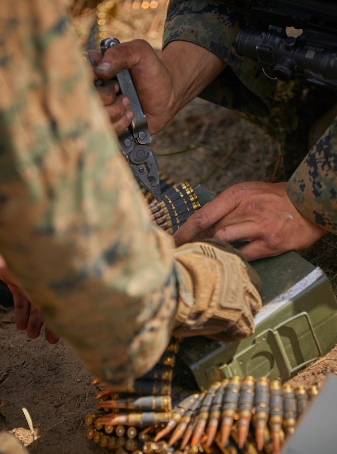 Marines with 1st Battalion, 24th Marine Regiment, 4th Marine Division, prepare ammunition for the M240B machine gun for a live fire and maneuver range during their annual training exercise on Camp Grayling, Mich., Aug. 18, 2020. The training and readiness manual establishes standards, regulations and policies regarding the training of Marines to ensure they can go, fight, and win our nation’s battles. (U.S. Marine Corps photo by Lance Cpl. Leslie Alcaraz)