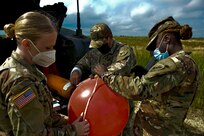 JOINT BASE MCGUIRE-DIX-LAKEHURST, N.J. – A drop zone detail with the U.S. Army's 404th Civil Affairs Battalion, United States Army Civil Affairs & Psychological Operations Command (Airborne), measure weather balloons in preparation for airborne operations here on Aug. 14, 2020. Soldiers assigned to drop zone support operations complete a list of tasks to include measuring wind knots and distance, which provide vital information to the execution of airborne operations.