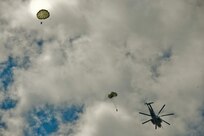 JOINT BASE MCGUIRE-DIX-LAKEHURST, N.J. – Paratroopers with 404th Civil Affairs Battalion, United States Civil Affairs & Psychological Operations Command (Airborne), jump out of a Sikorsky CH-53 Sea Stallion Helicopter during a large scale airborne operation here on Aug. 14, 2020. The unit conducted non-tactical airborne operations in order to maintain mission readiness and proficiency among their paratroopers.