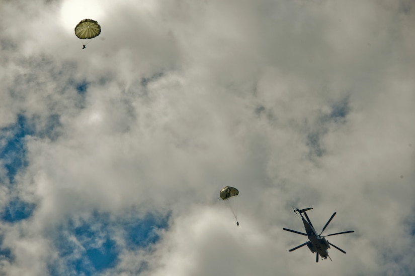 JOINT BASE MCGUIRE-DIX-LAKEHURST, N.J. – Paratroopers with 404th Civil Affairs Battalion, United States Civil Affairs & Psychological Operations Command (Airborne), jump out of a Sikorsky CH-53 Sea Stallion Helicopter during a large scale airborne operation here on Aug. 14, 2020. The unit conducted non-tactical airborne operations in order to maintain mission readiness and proficiency among their paratroopers.