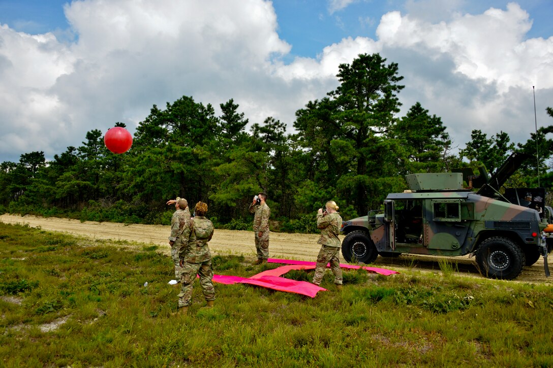 JOINT BASE MCGUIRE-DIX-LAKEHURST, N.J. – A drop zone detail with the U.S. Army Reserve’s 404th Civil Affairs Battalion, United States Civil Affairs & Psychological Operations Command (Airborne), deploy a weather balloon during a large scale airborne operation here on Aug. 14, 2020. Drop zone details and jump masters work together to measure wind speeds and knots as weather conditions can impact airborne operations.