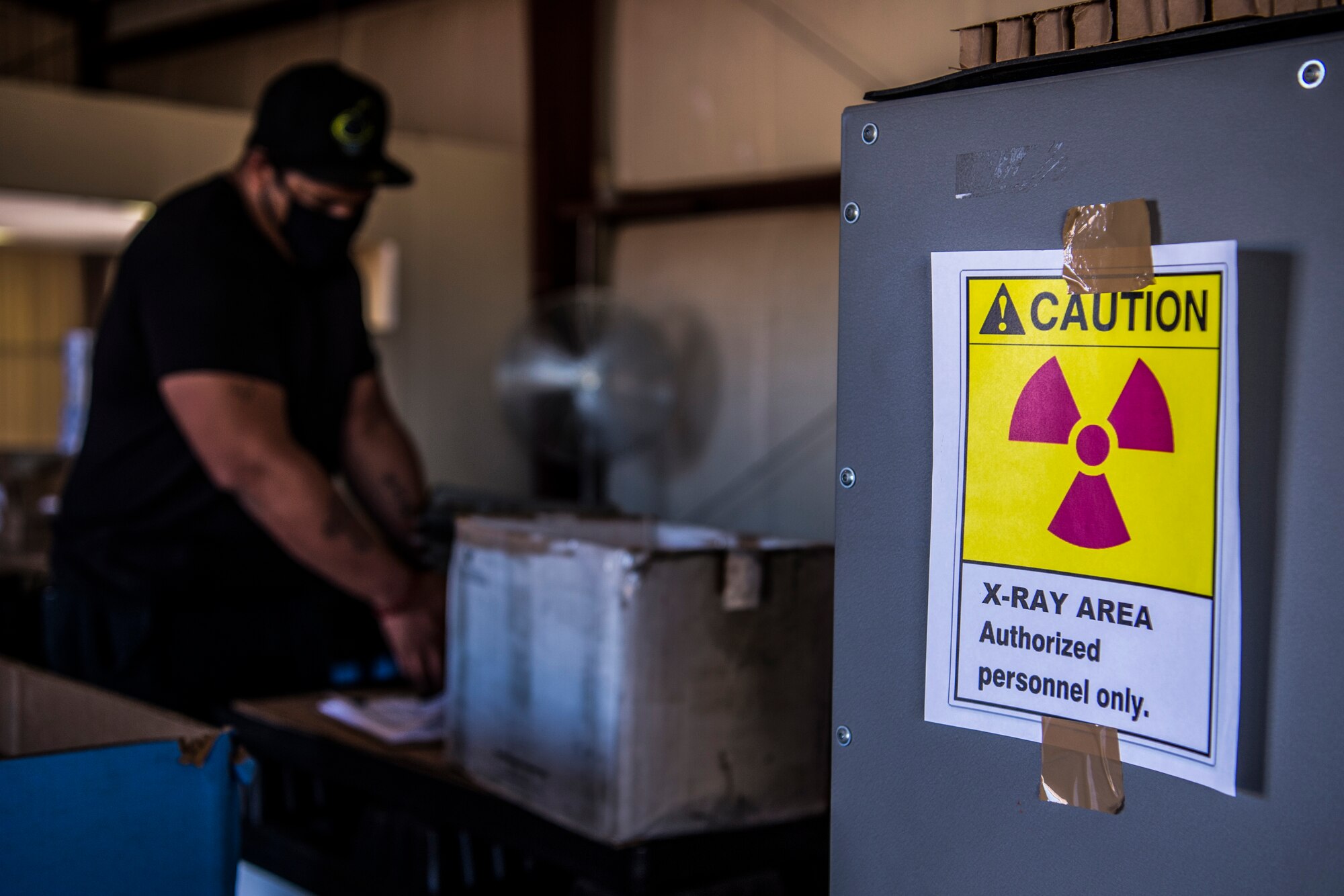 A Non-Destructive Testing Equipment team member loads tested hard armor body inserts into a shipping container at Cannon Air Force Base, N.M., Aug. 4, 2020. The armor plates are tested by an Armor Inspection System that uses x-rays to find cracks or faults in the structure. (U.S. Air Force photo by Staff Sgt. Luke Kitterman)