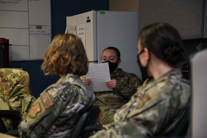 Staff Sgt. Victoria Hansen, 316th Medical Squadron shift leader, reads a safety brief at the Aeromedical Staging Facility at Joint Base Andrews, Md., Aug. 13, 2020. Safety briefings are held before the beginning of each mission to ensure adherence to precautions, emergency procedures and flight line protocols. (U.S. Air Force photo by Airman 1st Class Spencer Slocum)