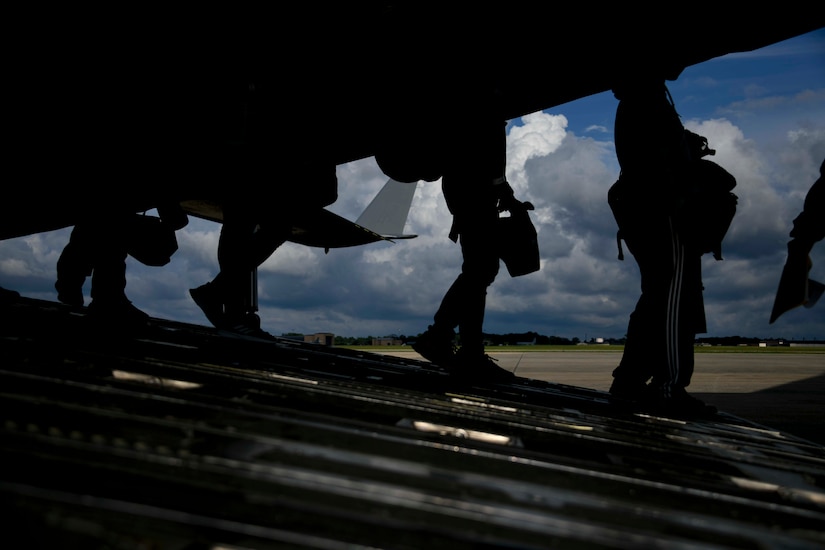 Patients walk off the back of a C-17 Globemaster III at Joint Base Andrews, Md., Aug. 13, 2020. JBA serves as the entry point in the United States for all returning injured or ill government personnel stationed overseas, before they continue on to their final destinations. (U.S. Air Force photo by Airman 1st Class Spencer Slocum)