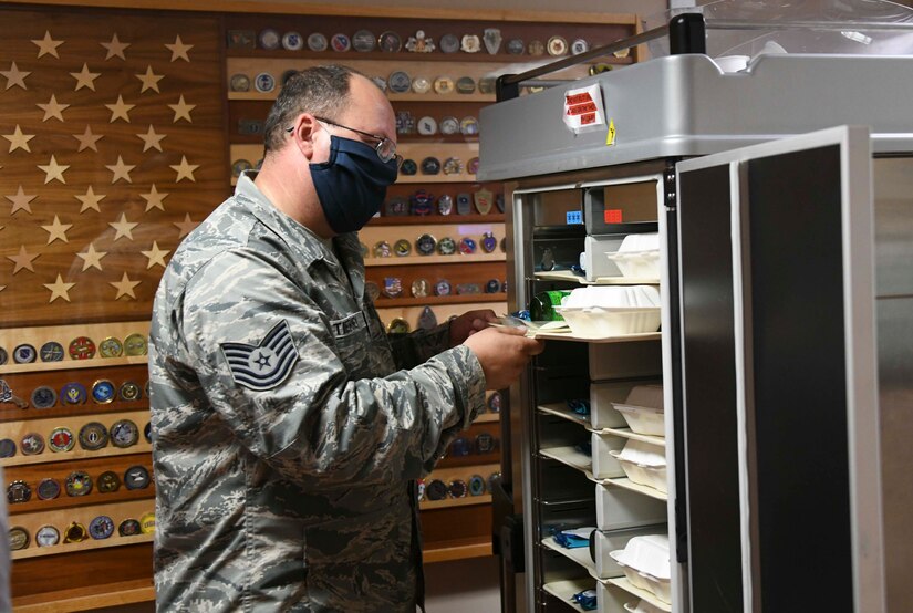 Tech. Sgt. James Tierney, 316th Aeromedical Squadron noncommissioned officer in-charge of the Aeromedical Staging Facility, picks up a tray of food for a patient at Joint Base Andrews, Md., Aug. 13, 2020. Along with being provided a room to stay for the night, patients are also provided a meal, snacks, drinks, toiletries and other basic essential items. (U.S. Air Force photo by Airman 1st Class Spencer Slocum)