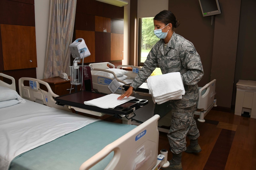 Airman 1st Class Maria Bandstra, 316th Aerospace Medicine Squadron medical technician, places a towel in a patient room at the Aeromedical Staging Facility at Joint Base Andrews, Md., Aug. 13, 2020. Prior to the arrival of patients, technicians prepare their rooms to ensure cleanliness and comfortability.  (U.S. Air Force photo by Airman 1st Class Spencer Slocum)