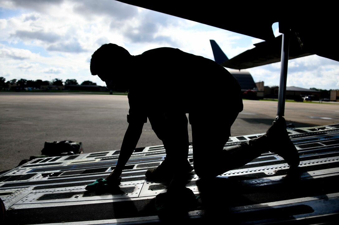 Airman 1st Class Manuel Arias, 316th Aeromedical Staging Facility medical technician, wipes off the hatch of a C-17 Globemaster III at Joint Base Andrews, Md., Aug. 13, 2020. In addition to tending to patients’ medical needs, technicians ensure the safety of patients and staff by taking extra precautions, such as wiping off potentially slippery surfaces so they do not fall. (U.S. Air Force photo by Airman 1st Class Spencer Slocum)