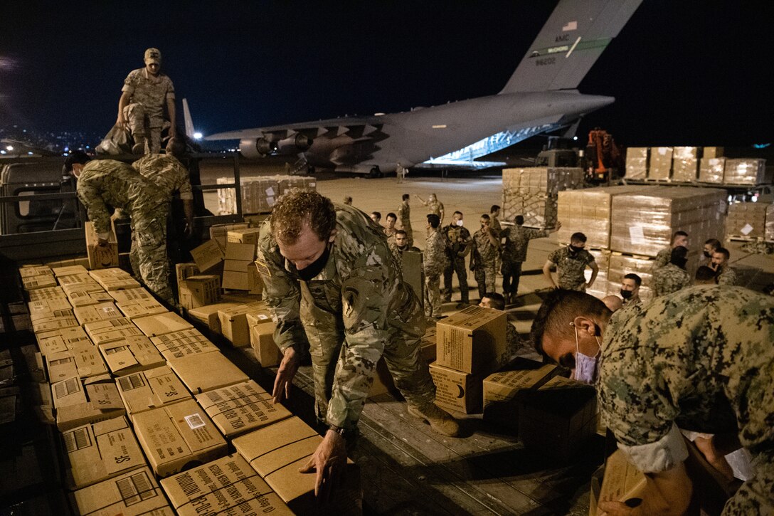 Lebanese and U.S. Armed Forces service members unload humanitarian aid supplies delivered by a U.S. Air Force C-17 Globemaster III at Beirut, Lebanon, Aug. 6, 2020. U.S. Central Command is continuing to coordinate with the Lebanese Armed Forces, the U.S. Embassy-Beirut and USAID to transport critical supplies as quickly as possible to support the needs of the Lebanese people. (U.S. Air Force photo by Staff Sgt. Justin Parsons)