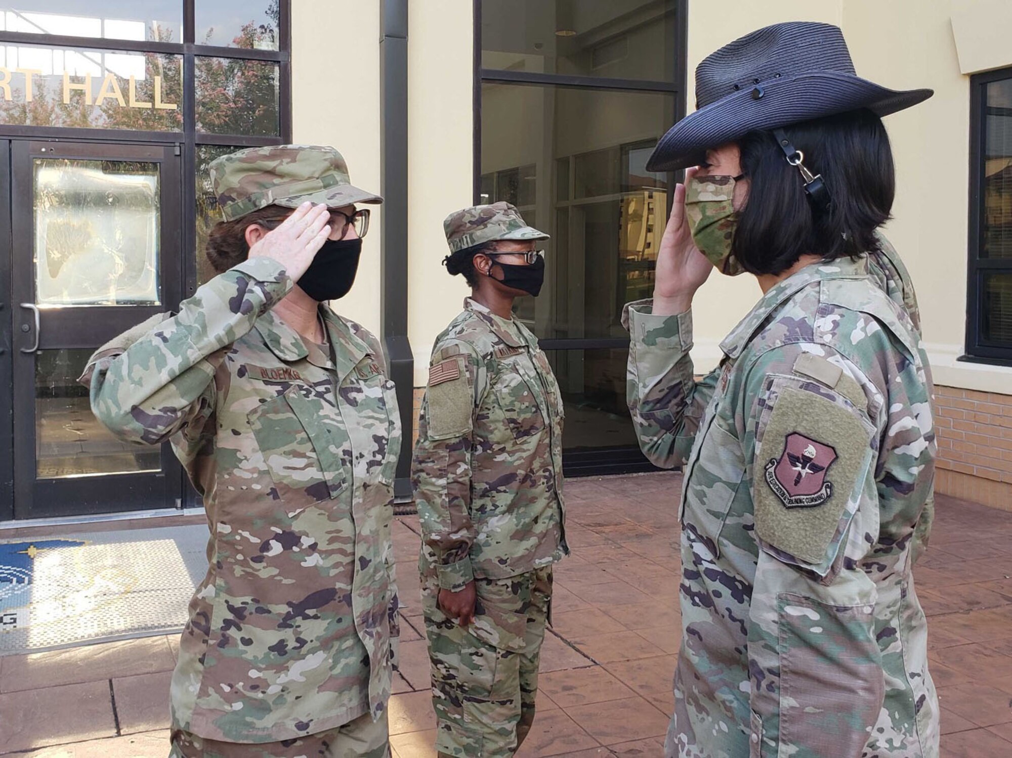 2nd Lt. Vicki Bloemker, left, returns a salute after graduating from Officer Training School, Maxwell Air Force Base, Ala. Before commissioning, Bloemker served as the Development and Training Flight chief at Dobbins, where she held the rank of master sergeant. (Courtesy photo)