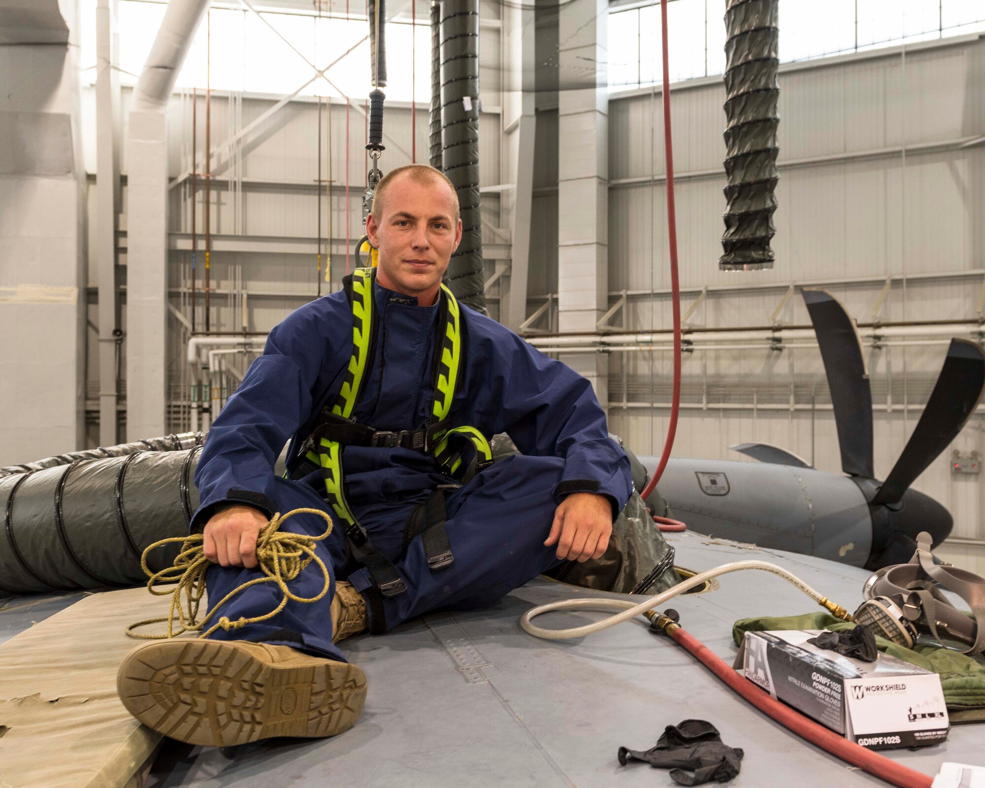 Air Force Reserve Staff Sgt. Tyler Blythe, 913th Maintenance Squadron, sits on top of aircraft's wing in his personal protection gear after he inspected the wing fuel tank of a C-130J Super Hercules at Little Rock Air Force Base, Ark., Aug. 6, 2020. Blythe enlisted into the active duty Air Force at 18 years old as a maintenance crew chief stationed in Arizona. (U.S. Air Force Reserve photo by Maj. Ashley Walker)