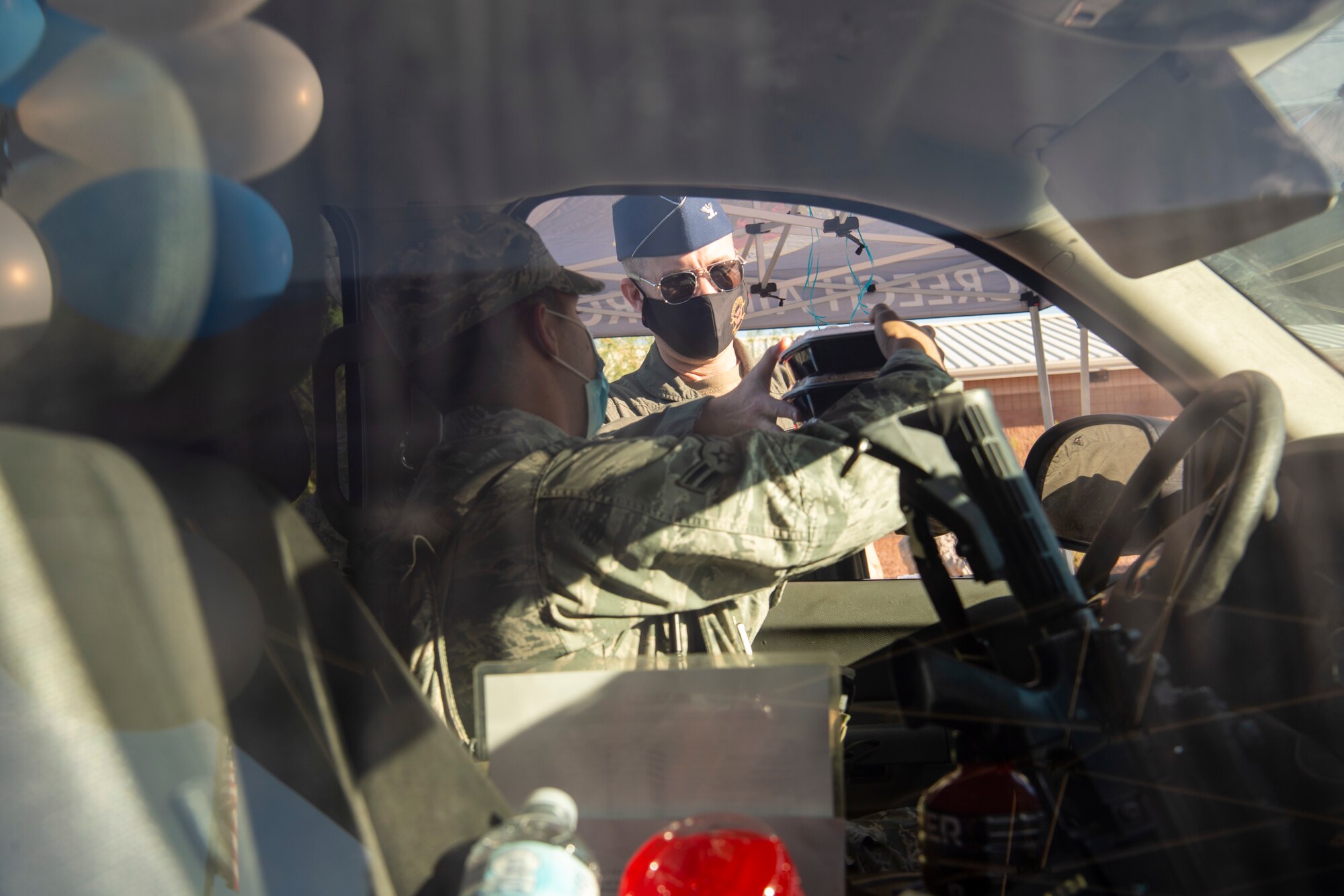 Col. Stephen Jones delivers meals to an Airmen through their driver's side window at Creech.