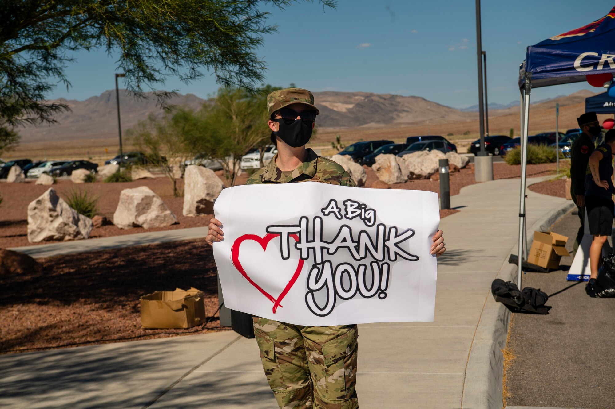Master Sgt. Sarah holds a home made sign that says Thank You!