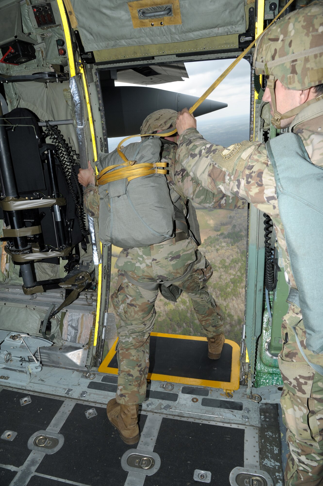 a soldier prepares to jump from an aircraft