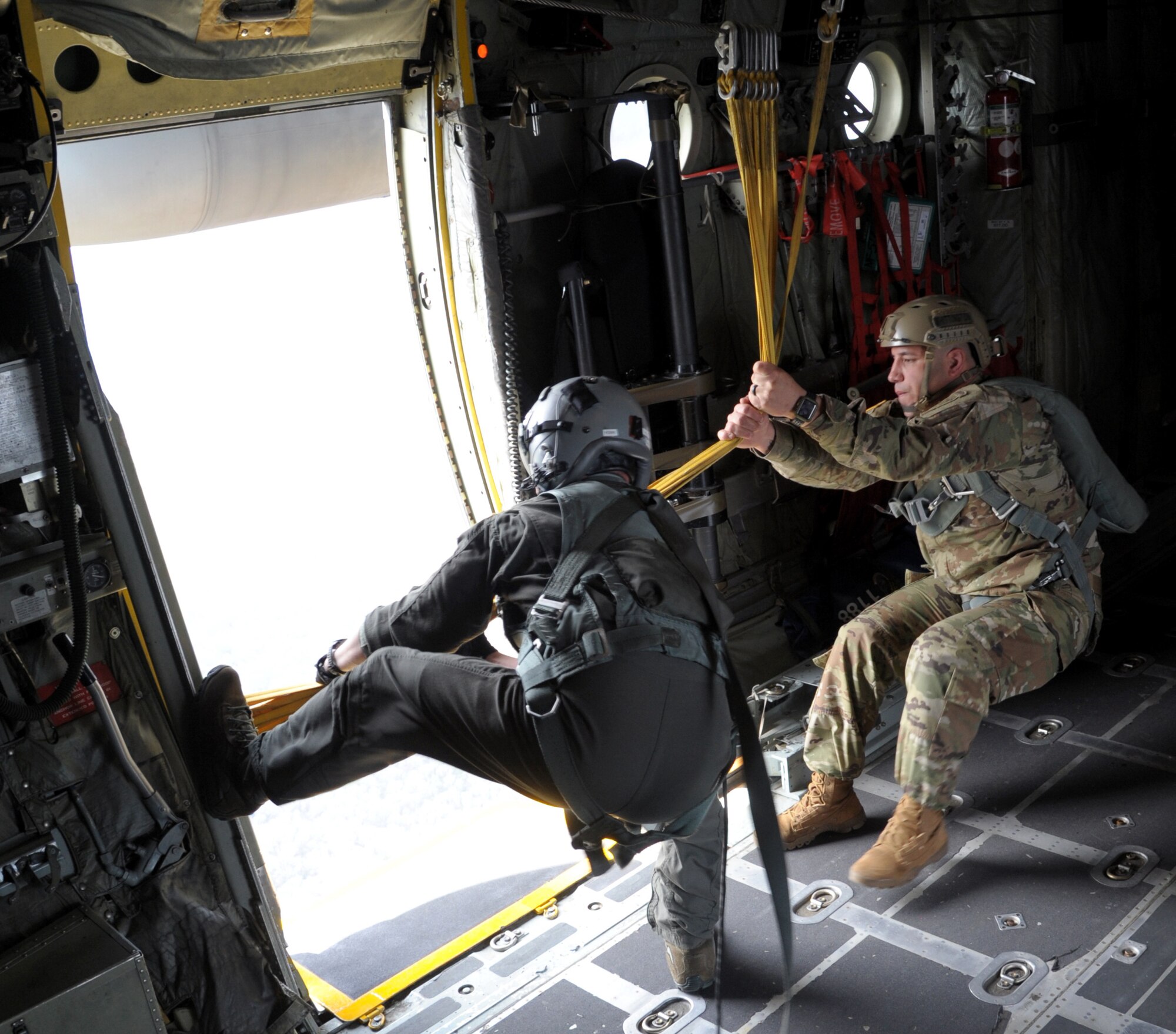 two men pull in static lines