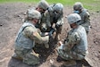 Soldiers from 2nd Squadron, 104th Cavalry Regiment, 56th Stryker Brigade Combat Team insert a detonation cord into a block of C4 plastic explosive during demolition familiarization training Aug. 14, 2020, at Fort Indiantown Gap, Pa.
