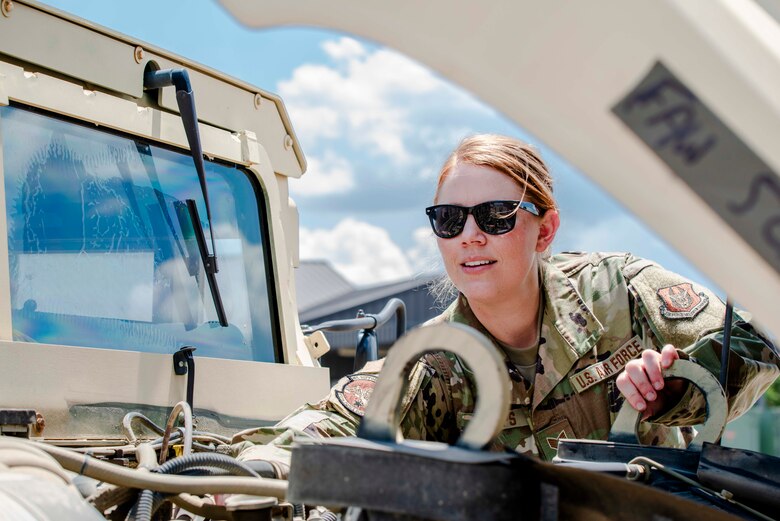 Air Force Reserve Staff Sgt. Tiah Phillips, inspects the engine of a Humvee Aug. 2, 2020, at Little Rock Air Force Base, Ark. Earlier in her career she cross-trained into vehicle operations, where she deployed to Kuwait and Iraq in 2011. Phillips drove dozens of convoy missions in tractor trucks, bringing back heavy equipment from forward operating bases as operations were drawn down. (U.S. Air Force Reserve photo by Maj. Ashley Walker)