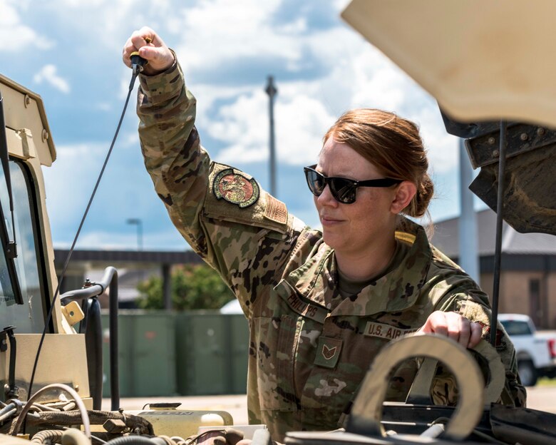 Air Force Reserve Staff Sgt. Tiah Phillips, inspects the engine oil of a Humvee on Aug. 2, 2020, at Little Rock Air Force Base, Ark. Earlier in her career she cross-trained into vehicle operations, where she deployed to Kuwait and Iraq in 2011. Phillips drove dozens of convoy missions in tractor trucks, bringing back heavy equipment from forward operating bases as operations were drawn down. (U.S. Air Force Reserve photo by Maj. Ashley Walker)