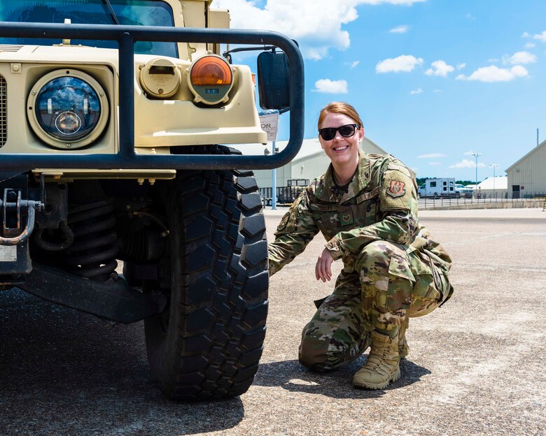 Air Force Reserve Staff Sgt. Tiah Phillips, inspects the tire of a Humvee on Aug. 2, 2020, at Little Rock Air Force Base, Ark. Earlier in her career she cross-trained into vehicle operations, where she deployed to Kuwait and Iraq in 2011. Phillips drove dozens of convoy missions in tractor trucks, bringing back heavy equipment from forward operating bases as operations were drawn down. (U.S. Air Force Reserve photo by Maj. Ashley Walker)