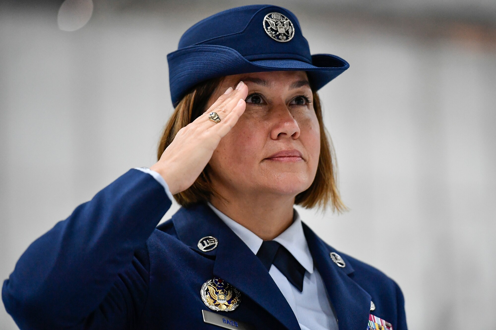 close up photograph of Chief Master Sergeant JoAnne Bass with her hand up in a salute