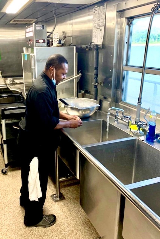 IN THE PHOTO, Dredge Hurley Ship Keeper Curtis Williams works in the kitchen area. Williams is celebrating a little over 30 years of service with the Memphis District U.S. Army Corps of Engineers.