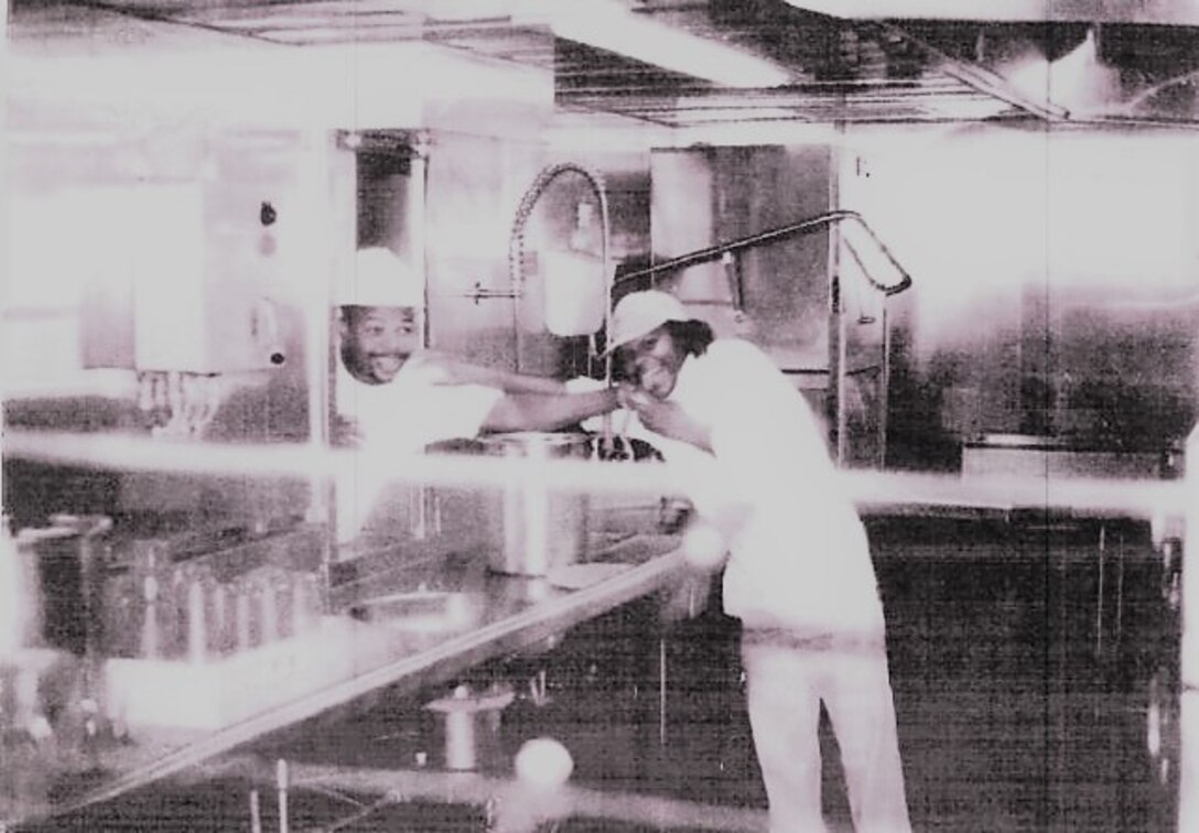 IN THE PHOTO, Dredge Hurley Ship Keeper Curtis Williams poses in the kitchen area with a fellow coworker. Williams is celebrating a little over 30 years of service with the Memphis District U.S. Army Corps of Engineers.