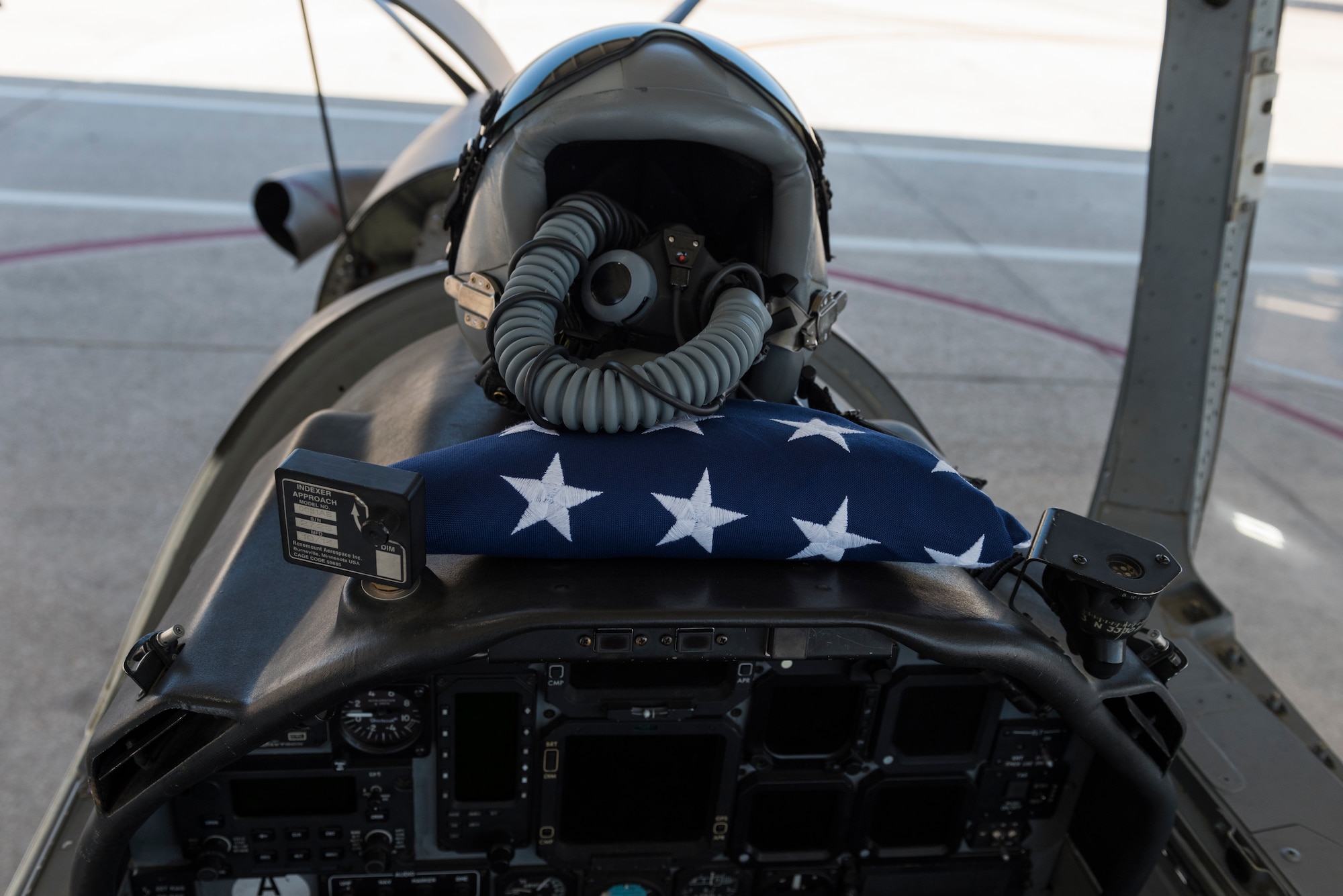 Maj. Camber Governski, 96th Flying Training Squadron T-6A Texan II chief pilot, rested her helmet and a flag on her dashboard of the T-6 she prepares for flight on Aug. 14, 2020 at Laughlin Air Force Base, Texas. The flags they are to fly are for the families of the U.S. Customs and Border Protection service members who were lost to COVID-19. Governski said, “Flying the flags for our brothers in Border Patrol was an honor, and it made us feel a part of something bigger and true members of the community.” (U.S. Air Force photo by Senior Airman Anne McCready)